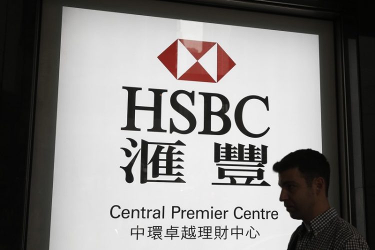 HSBC net profit falls 53%, bank to sell assets in overhau