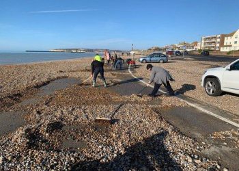 Seaford runners clear shingle covered promenade by hand after storms
