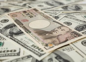 Slides to fresh session low, risks breaking below 106.00 mark
